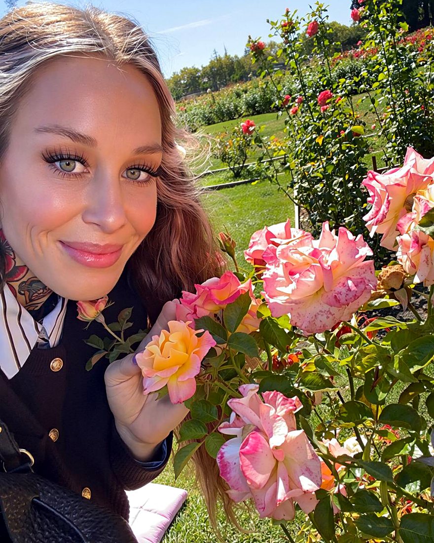 Amy smiling in a rose garden